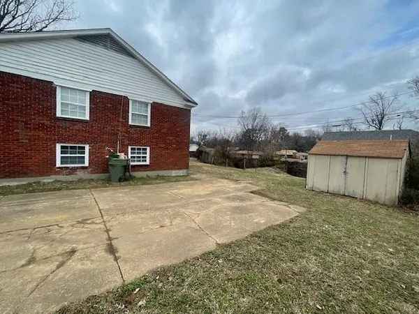 a view of a house with a yard and garage