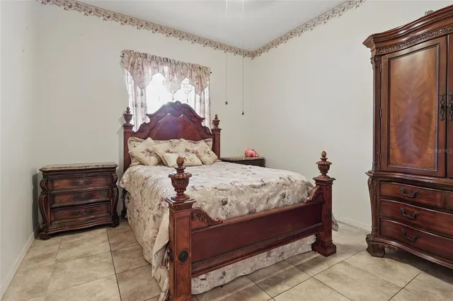 a bed sitting in a room next to a window