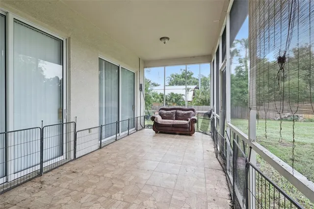 a view of a balcony with chairs and floor to ceiling window