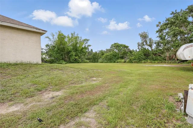 a view of a backyard with a garden and entertaining space