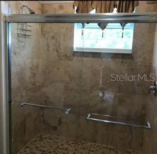 a open kitchen with a dining table chairs and white cabinets