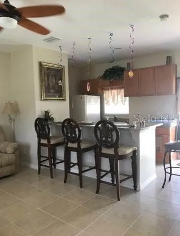 a bathroom with a granite countertop sink a mirror and a toilet