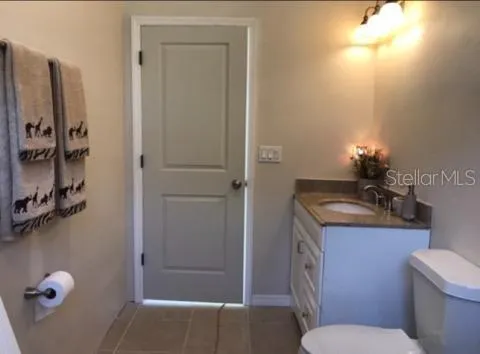 a view of a bedroom with a bed and a chandelier fan