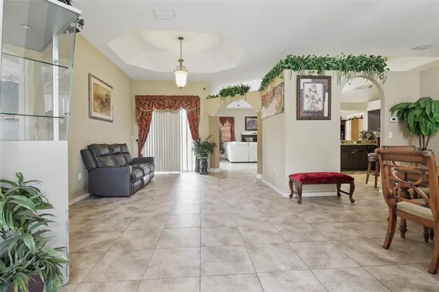 a living room with furniture a couch and a potted plant