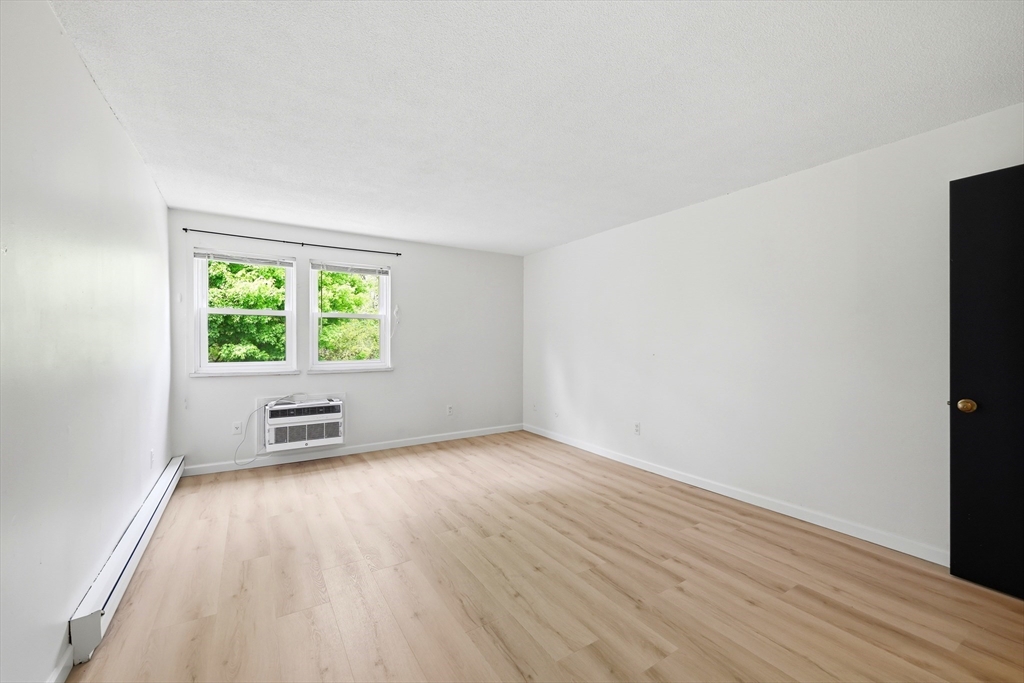 80 Damon Road, Unit 2303 Northampton, MA 01060 - Photo 17 of 23 an empty room with windows