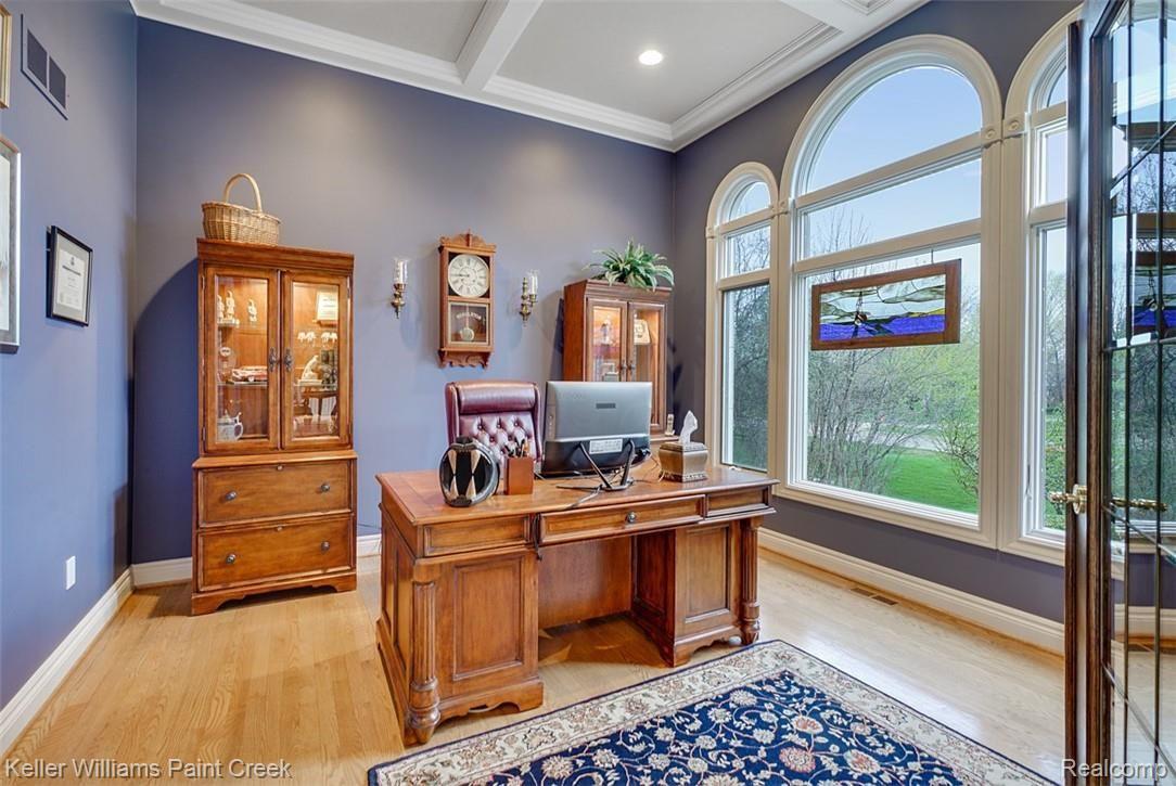 525 Sheldon Court Rochester, MI 48306 - Photo 30 of 66 This office/library with hardwood floors boasts architectural details such as French Doors, a Coffered Ceiling and three Arched Windows