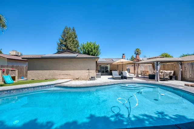 a front view of a house with a yard patio and fire pit