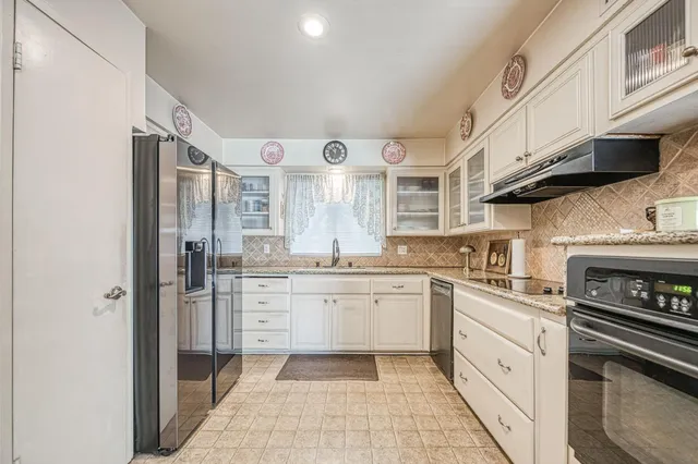 a kitchen with a sink stainless steel appliances and cabinets