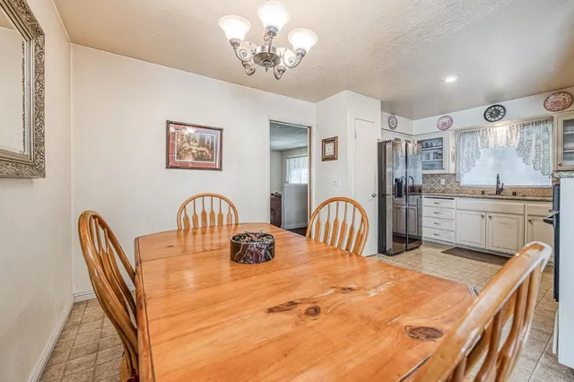 a view of a kitchen with a dining table and chairs