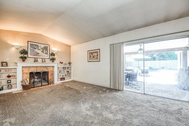 a view of a livingroom with an empty space and a fireplace