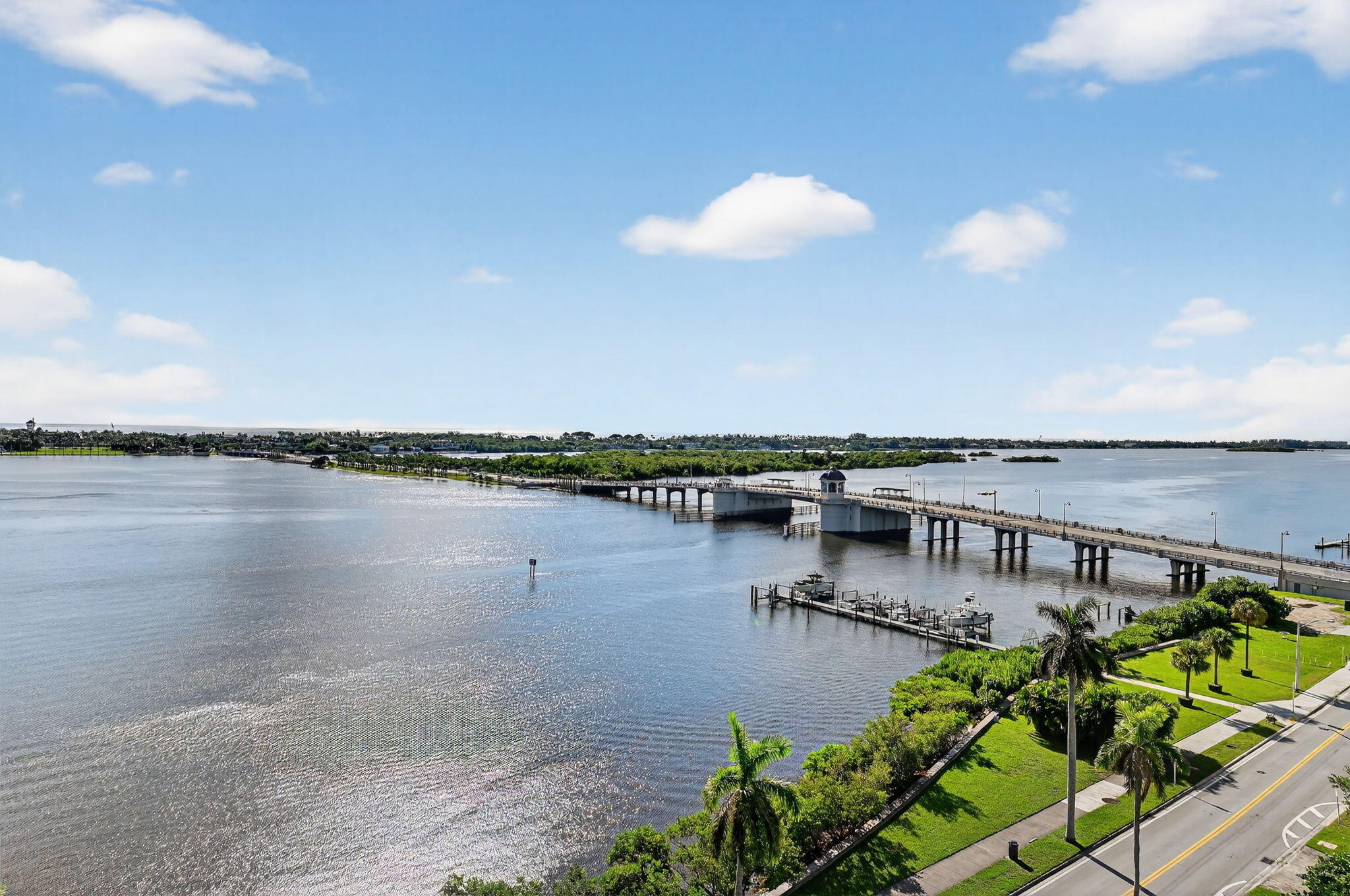 3800 Washington Road, Unit 1107 West Palm Beach, FL 33405 - Photo 12 of 49 a view of a lake with a floor to ceiling window and wooden floor