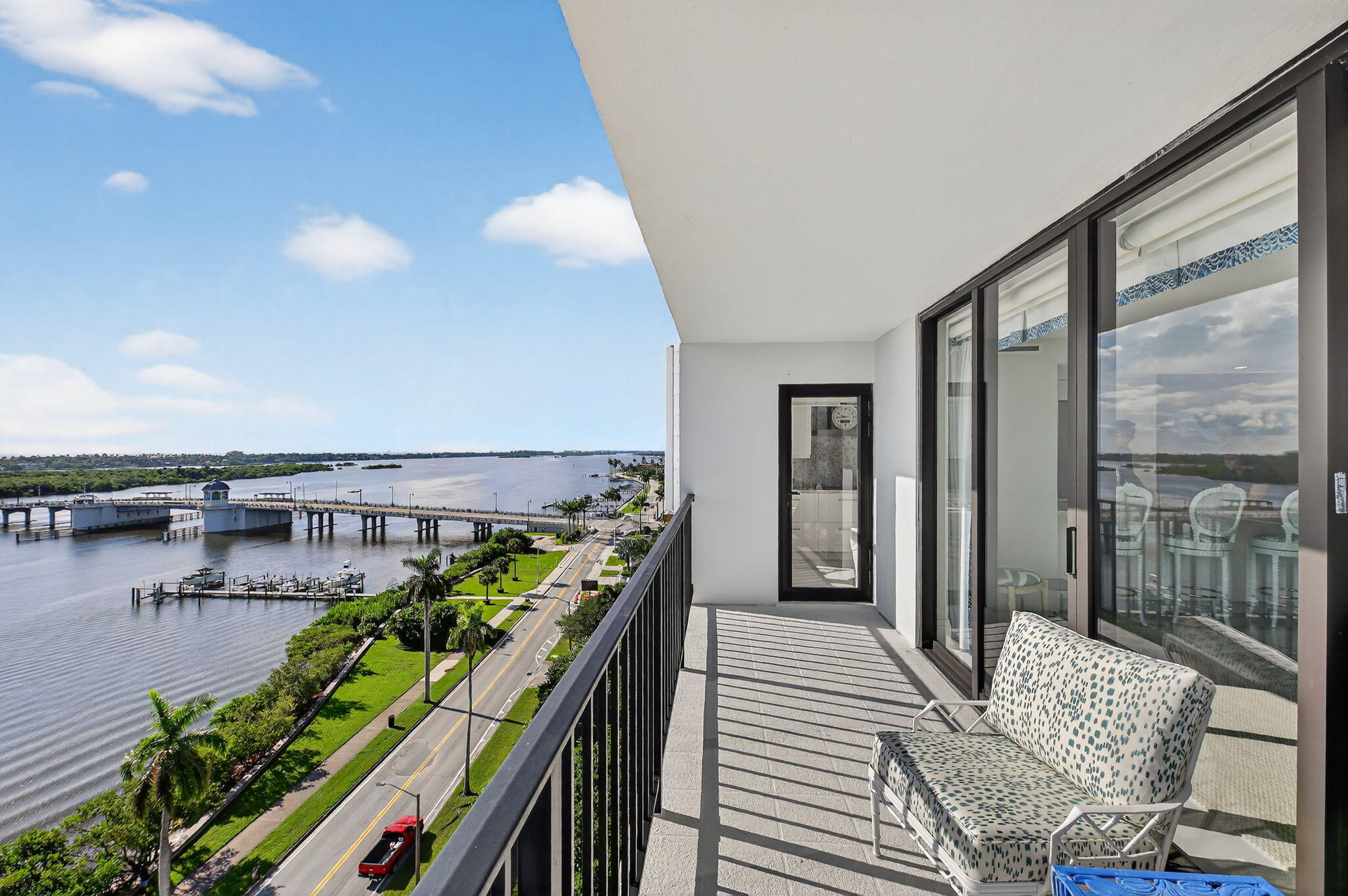 3800 Washington Road, Unit 1107 West Palm Beach, FL 33405 - Photo 13 of 49 a balcony with furniture and a potted plant