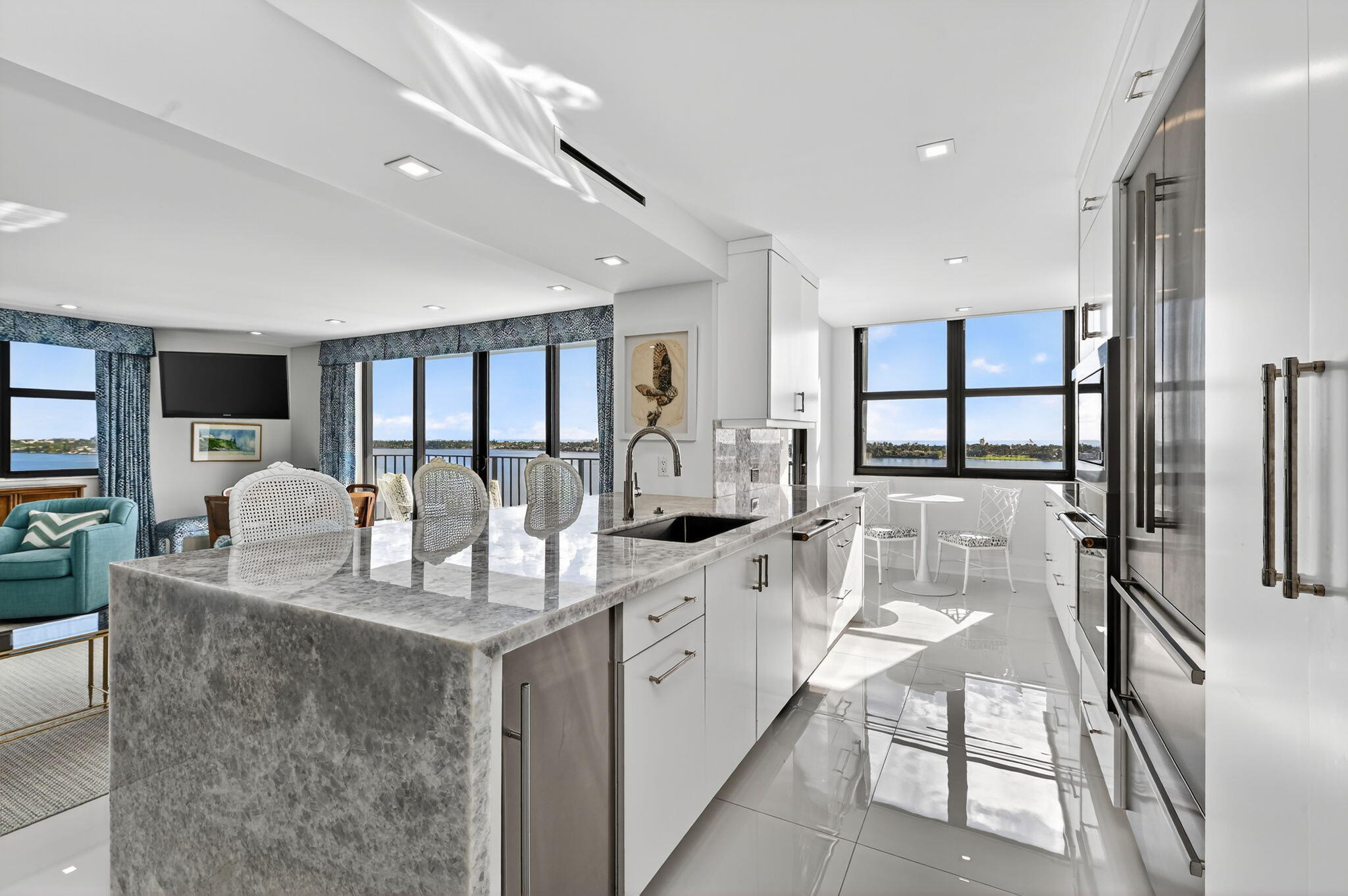 3800 Washington Road, Unit 1107 West Palm Beach, FL 33405 - Photo 17 of 49 a large white kitchen with stainless steel appliances granite countertop a sink and cabinets
