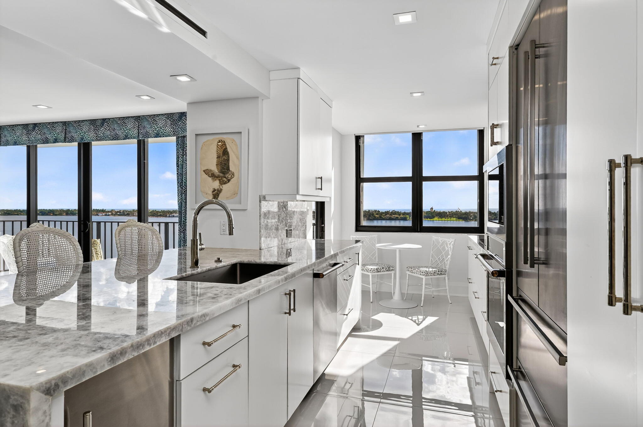 3800 Washington Road, Unit 1107 West Palm Beach, FL 33405 - Photo 18 of 49 a large kitchen with granite countertop a large window and stainless steel appliances