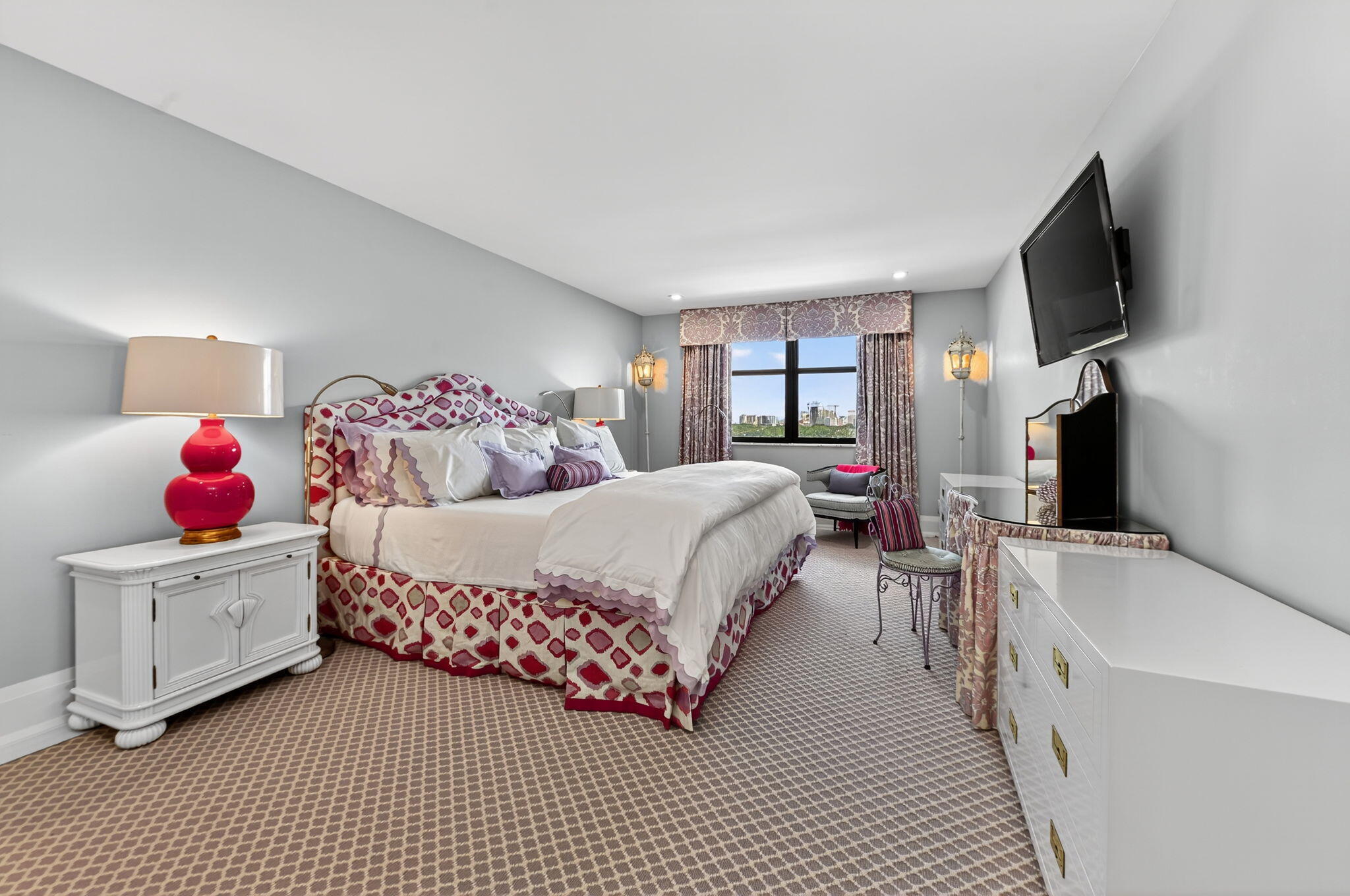 3800 Washington Road, Unit 1107 West Palm Beach, FL 33405 - Photo 22 of 49 a bedroom with a bed and a flat screen tv