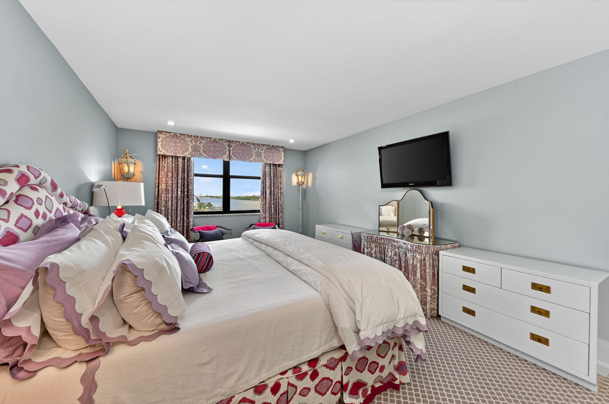 3800 Washington Road, Unit 1107 West Palm Beach, FL 33405 - Photo 23 of 49 a bedroom with a bed and a flat screen tv