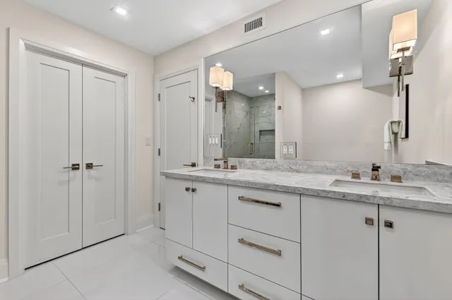 a bathroom with a granite countertop sink mirror and double