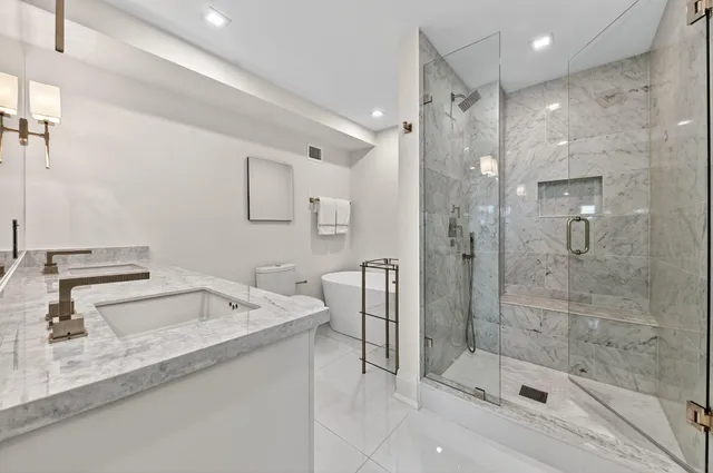 a bathroom with a shower sink and mirror
