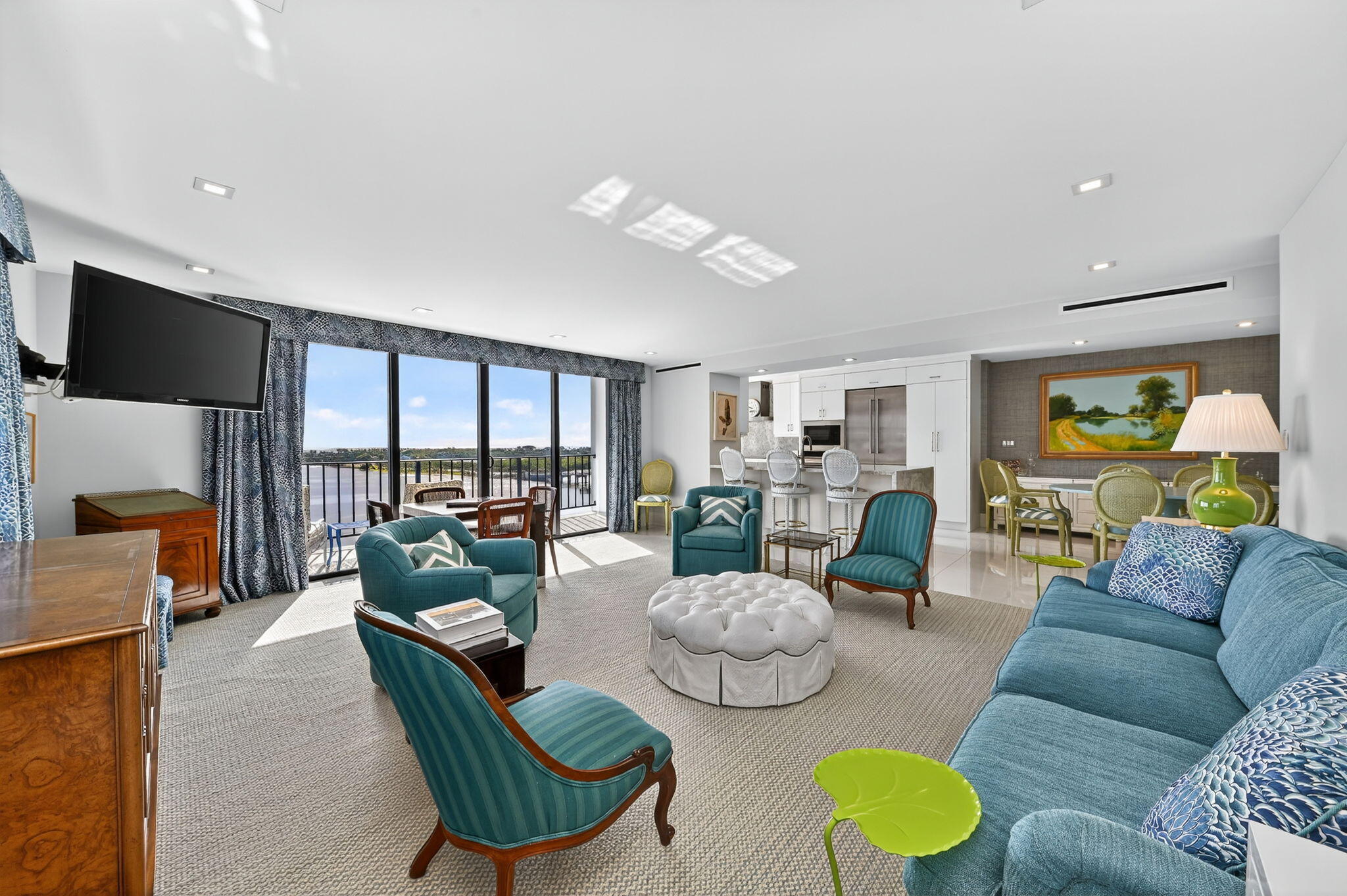 3800 Washington Road, Unit 1107 West Palm Beach, FL 33405 - Photo 4 of 49 a living room with furniture and a flat screen tv