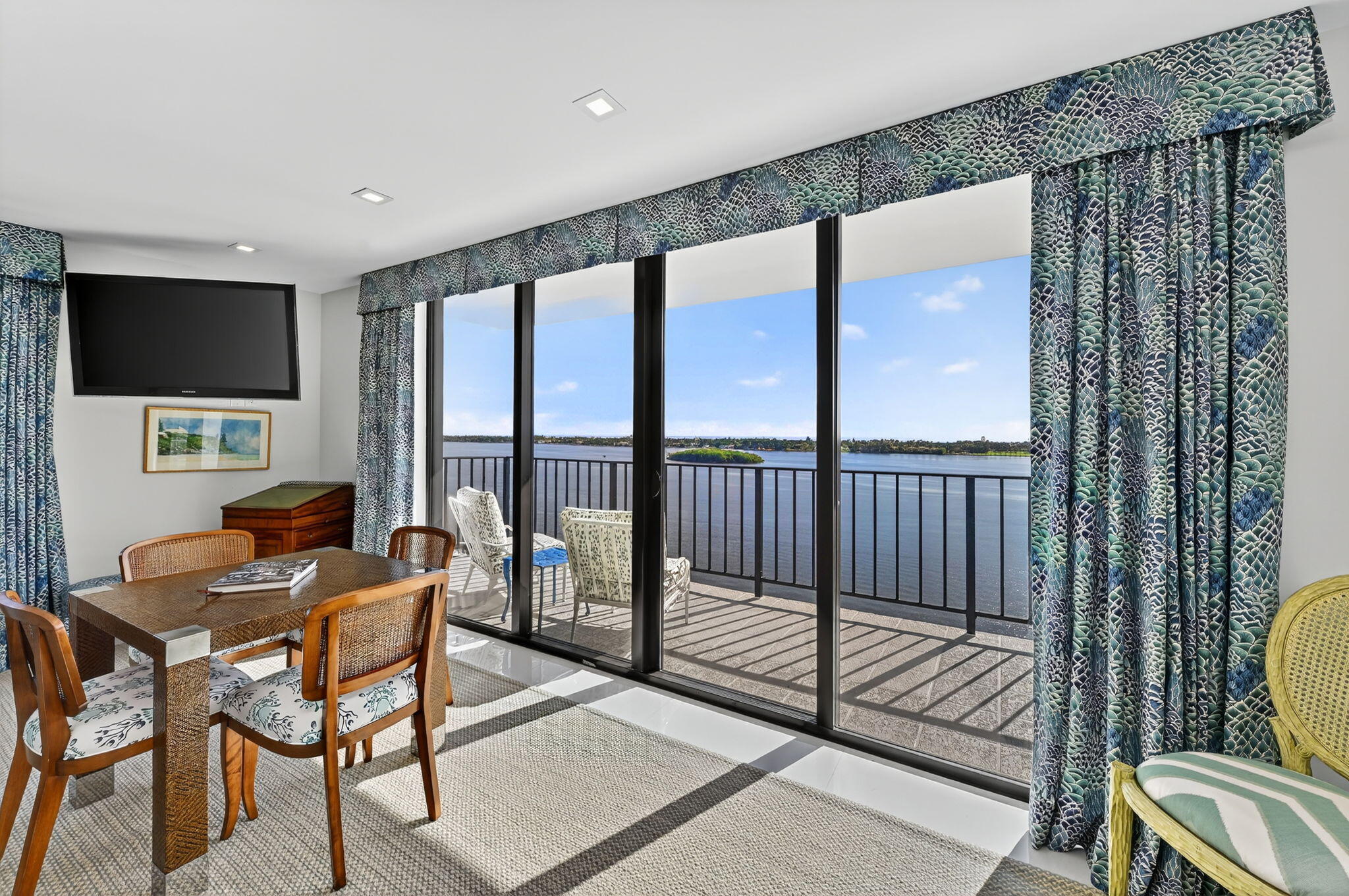 3800 Washington Road, Unit 1107 West Palm Beach, FL 33405 - Photo 6 of 49 a living room with furniture and a flat screen tv