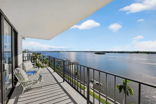a balcony with wooden floor and lake view