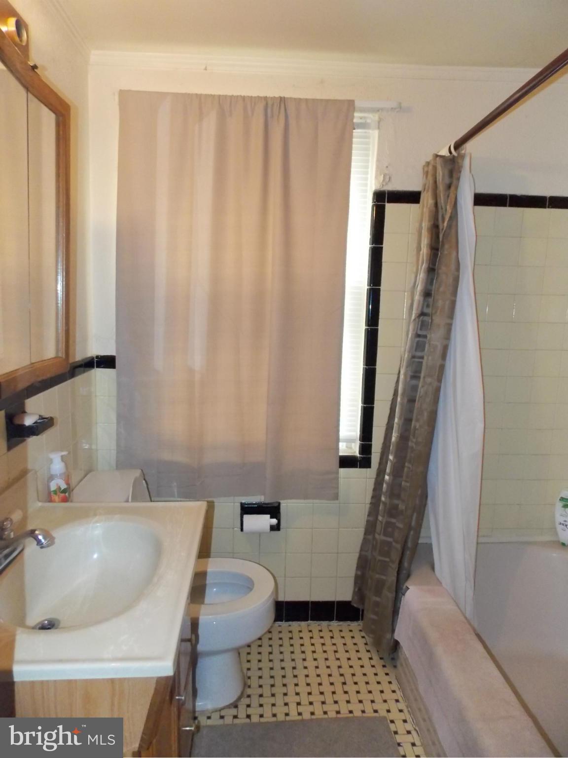5021 Sunset Road Baltimore, MD 21215 - Photo 13 of 26 a bathroom with a sink toilet and shower