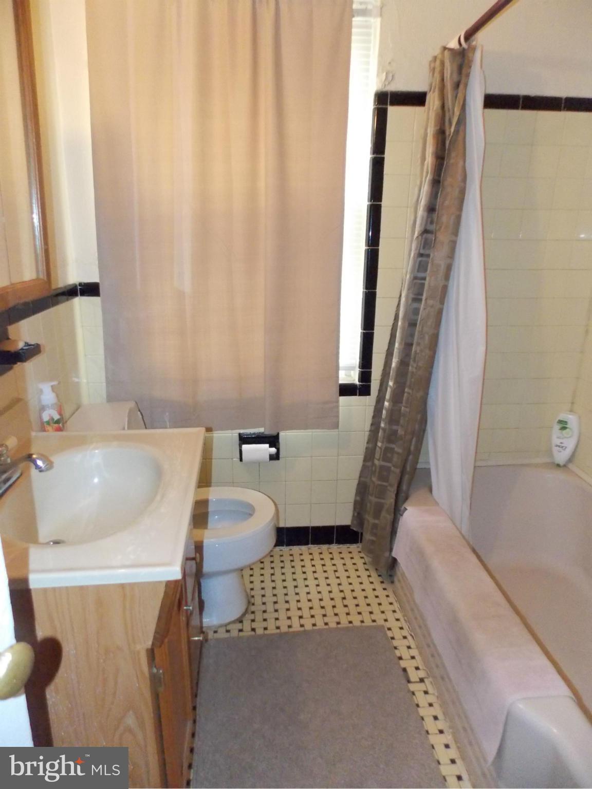 5021 Sunset Road Baltimore, MD 21215 - Photo 14 of 26 a bathroom with a sink and toilet