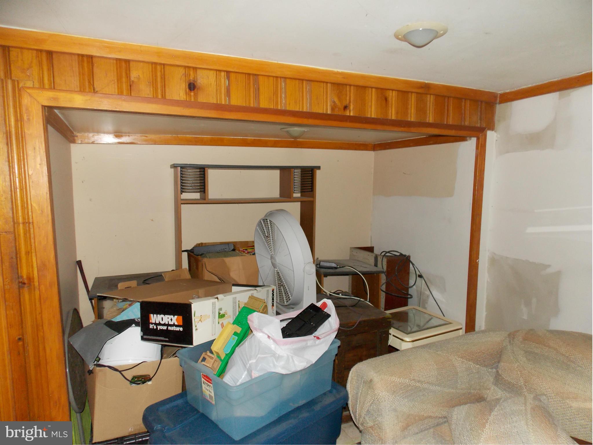 5021 Sunset Road Baltimore, MD 21215 - Photo 20 of 26 a bedroom with a bed and gym equipment