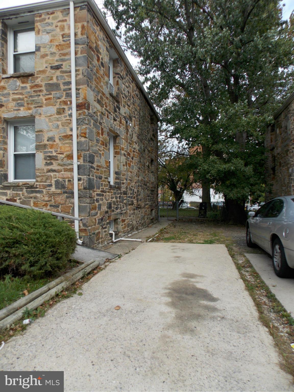 5021 Sunset Road Baltimore, MD 21215 - Photo 23 of 26 a view of yard with car parked in front of house