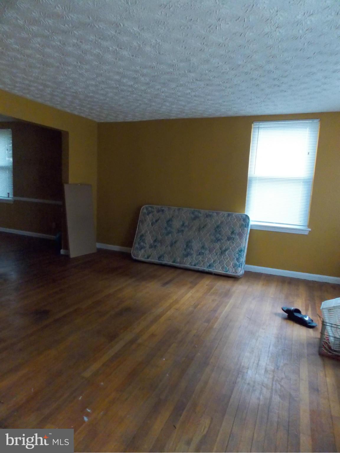 5021 Sunset Road Baltimore, MD 21215 - Photo 4 of 26 a living room with hard wood floors and a window