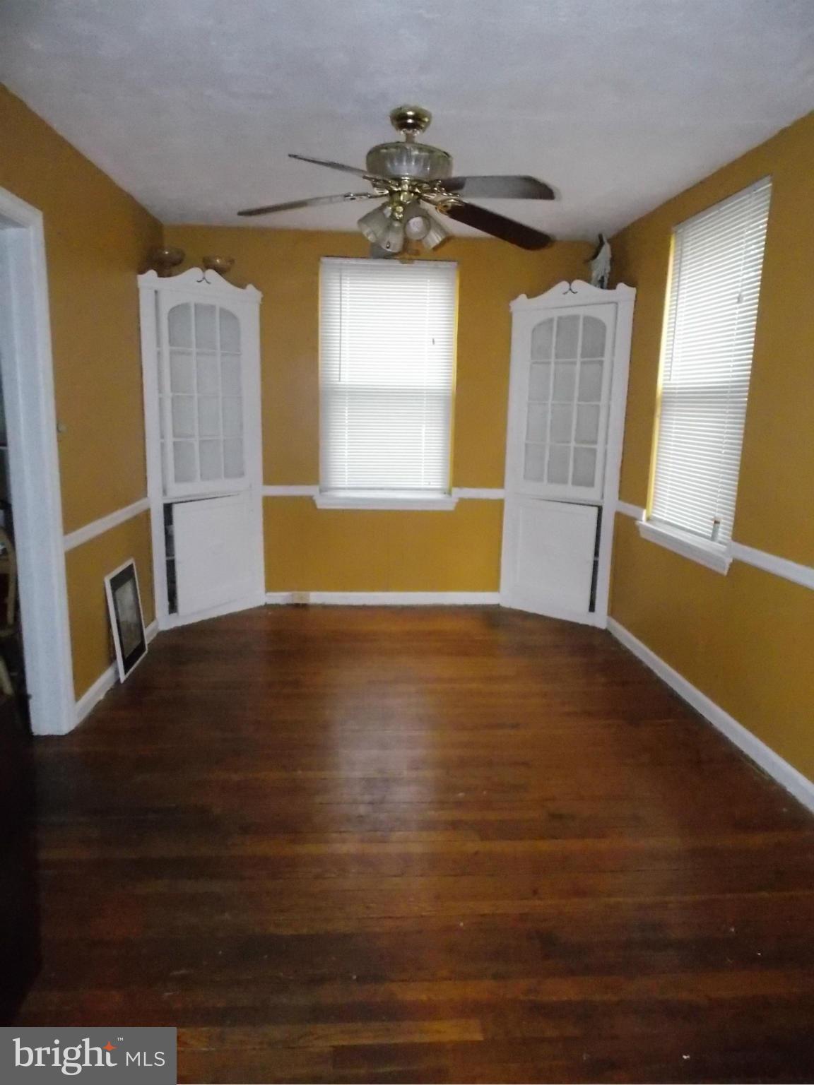 5021 Sunset Road Baltimore, MD 21215 - Photo 6 of 26 a view of a room with wooden floor and a window