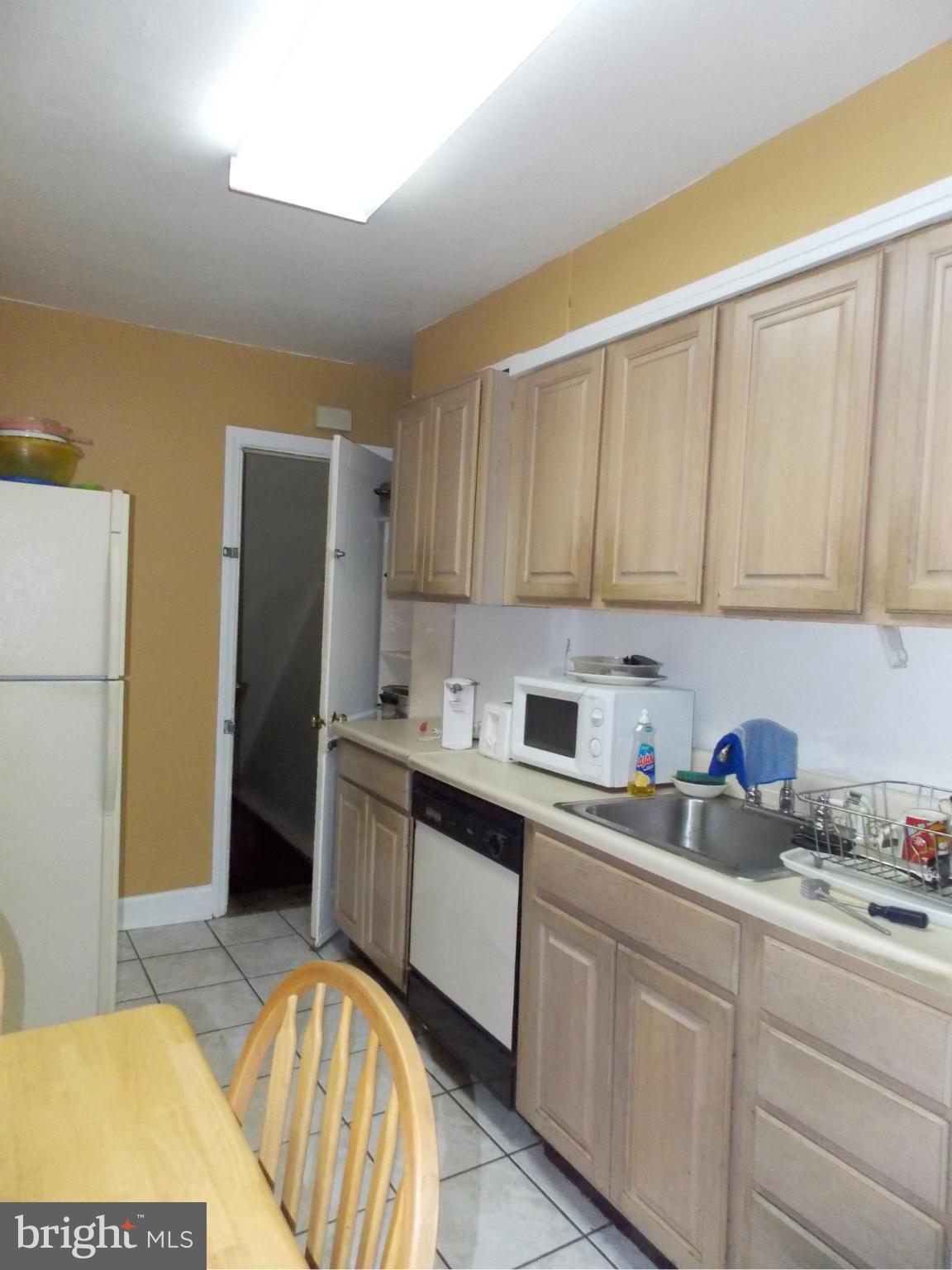 5021 Sunset Road Baltimore, MD 21215 - Photo 8 of 26 a kitchen with stainless steel appliances granite countertop a refrigerator sink and stove