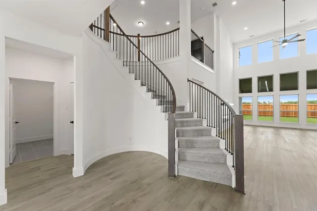 a kitchen with kitchen island sink stove and cabinets