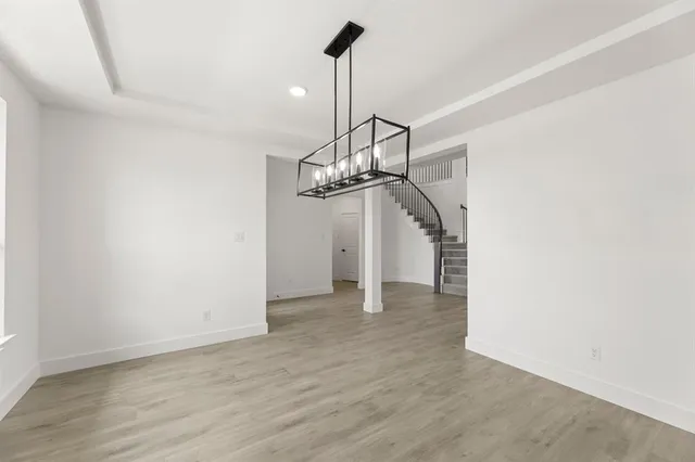 a kitchen with stainless steel appliances a stove and a wooden floors