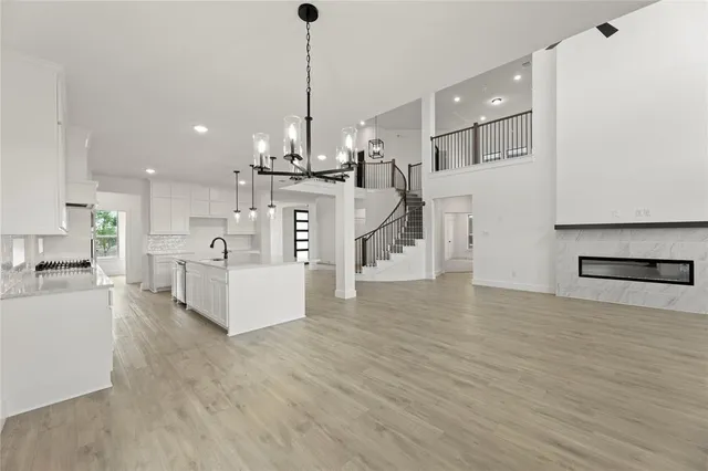 a view of a room with wooden floor ceiling fan and window