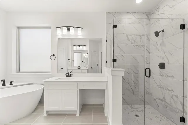 a bathroom with a bathtub shower sink and mirror