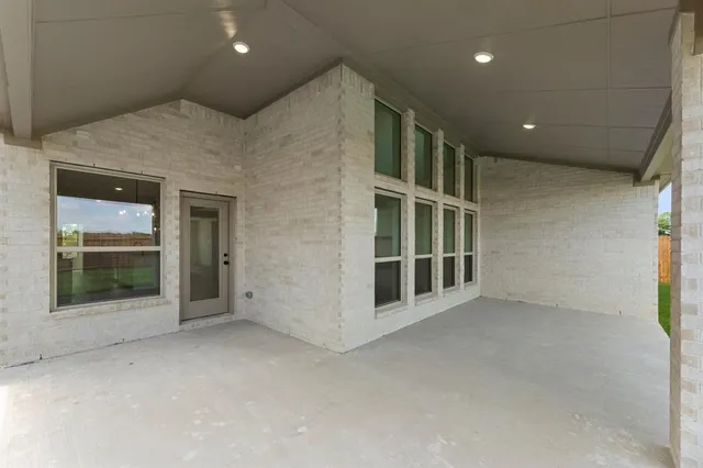 an empty room with wooden floor and window