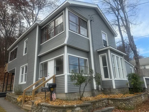 a front view of a house with a yard