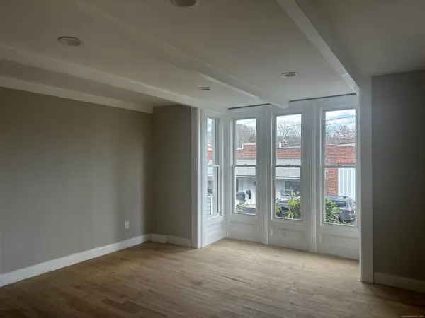 an empty room with windows and closet