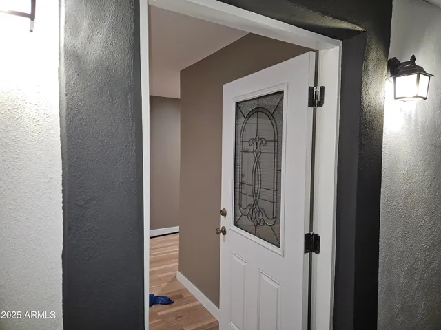 a view of a livingroom with wooden floor and furniture