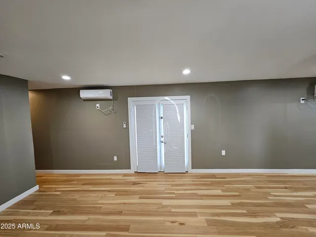 a view of a livingroom with an empty space and a window