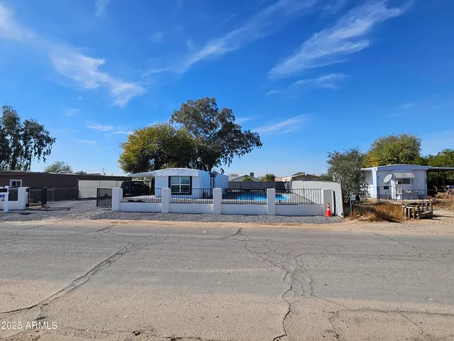a view of a house with large space and a car parked in front of it