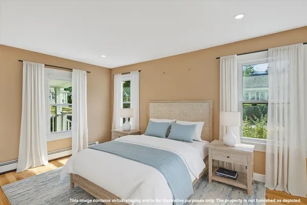 a bedroom with a large bed and a window