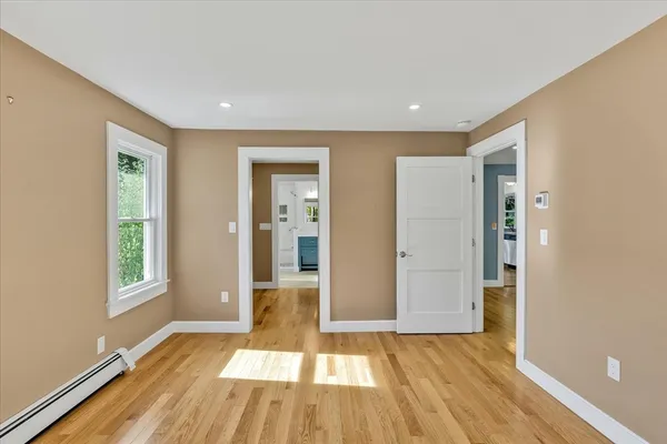 wooden floor in an empty room with a window