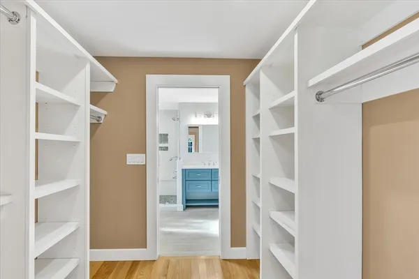 a view of a hallway with wooden floor and entryway