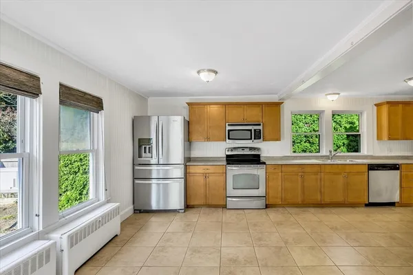 a kitchen with a stove a sink and a refrigerator