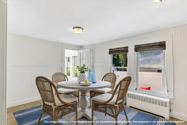 a dining room with furniture and window