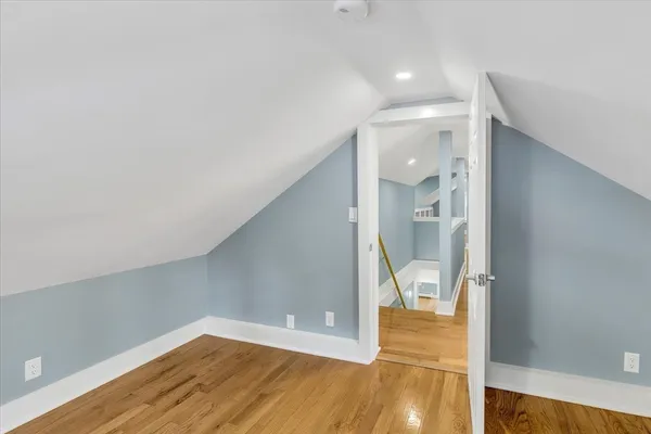 a view of hallway with wooden floor