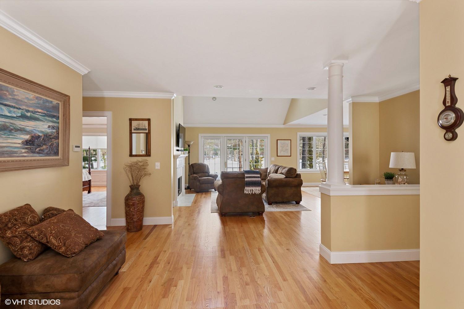101 Reflection Drive Sandwich, MA 02563 - Photo 2 of 15 a living room with furniture fireplace and wooden floor