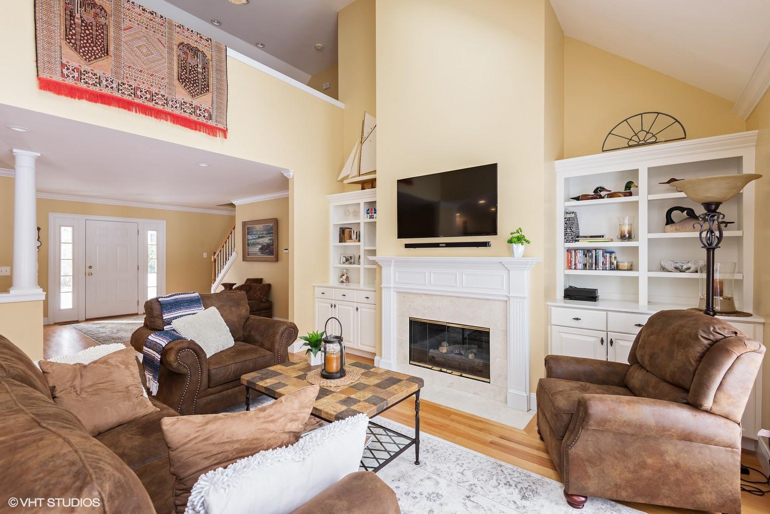 101 Reflection Drive Sandwich, MA 02563 - Photo 4 of 15 a living room with fireplace furniture and a flat screen tv